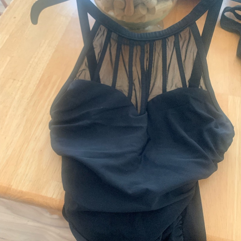 Black one piece. NO size listed classic drape in tummy area. Nice back.